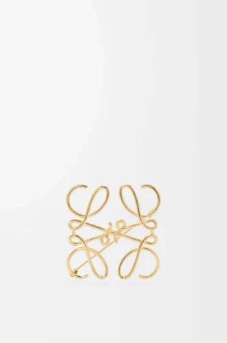 Anagram-brosch i metall Guld