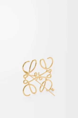 Anagram-brosch i metall Guld