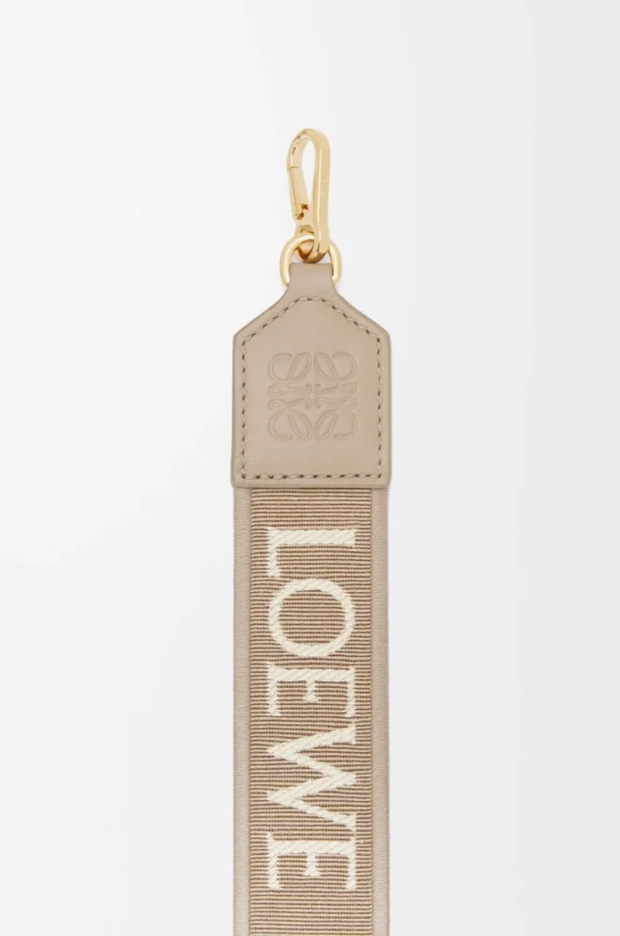Anagram-rem i jacquard och kalvskinn Sand Anagram-rem i jacquard och kalvskinn Sand