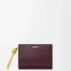 Kompakt plånbok med knut i glänsande nappa kalvskinn Mörk burgundy/Ljus citrin Kompakt plånbok med knut i glänsande nappa kalvskinn Mörk burgundy/Ljus citrin