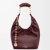 Liten Squeeze-väska i mjukt nappa-lammskinn Mörk burgundy Liten Squeeze-väska i mjukt nappa-lammskinn Mörk burgundy